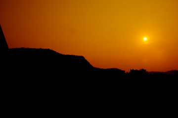 Sun setting over hills