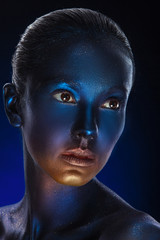 Beauty fashion Girl with colorful make-up, blue Paint on Skin. H