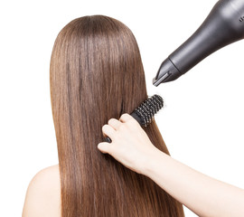 Drying long brown hair with  hairdryer and comb isolated.