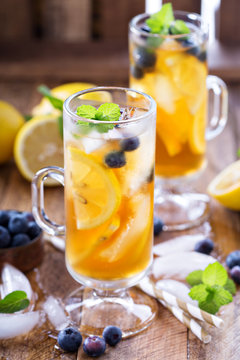 Iced tea with blueberries and lemon slices