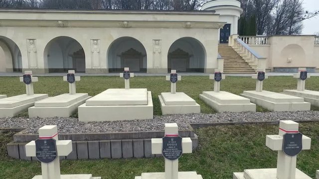 Polish Grave in Lviv. White Crosses and Flowers on the Graves. the Camera Flies Over the Graves of Those Killed in the War Poles. the Crosses Are Decorated With Penta Polish Flag. Grey Sad Weather.