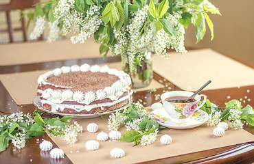 Summer cup of coffee with chocolate  pie and cherry flowers on t