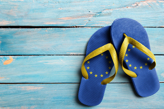 Thongs with flag of EU, on blue wooden boards