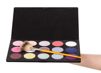Makeup artist's hand holding  palette eyeshadow isolated on white.