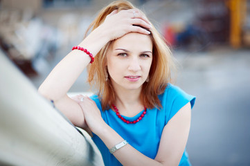 Young beautiful woman in blue, close-up, look into the camera.