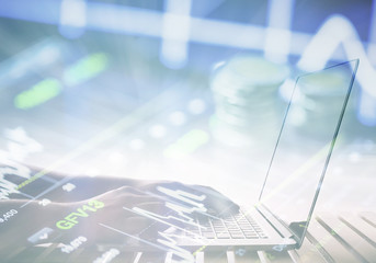 working on laptop with business graph background