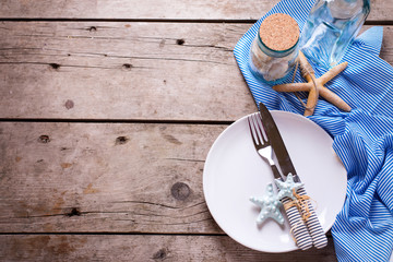 Marine table setting on aged wooden background.