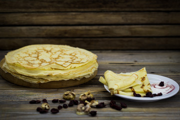 juicy decorated pancakes on a plate  wooden background