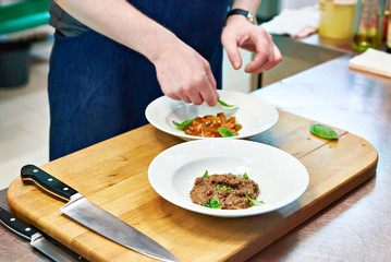 Cooking vegetable appetizers and salads in kitchen of restaurant