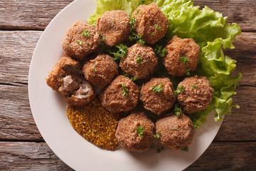Dutch meat croquettes Bitterballen and mustard close up. horizontal top view 
