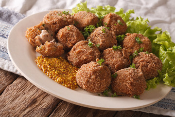 Netherlandish cuisine: meat balls Bitterballen and mustard close up. horizontal

