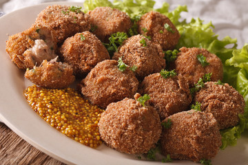 Dutch meat croquettes Bitterballen and mustard close up. Horizontal
