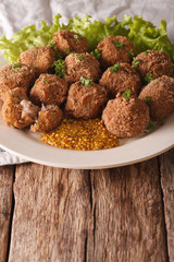 Dutch meat croquettes Bitterballen and mustard close up. vertical
