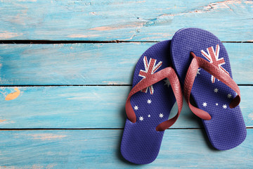 Thongs with flag of Australia, on blue wooden boards - obrazy, fototapety, plakaty