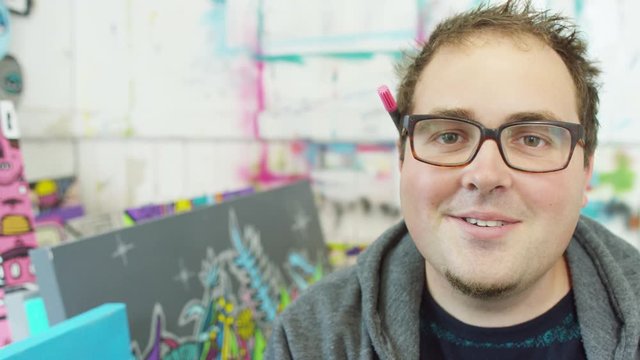  Portrait of smiling modern graphic artist in his studio.