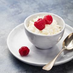 Fresh cottage cheese with berries, raspberries for breakfast closeup