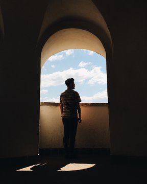 Lonely Man Silhouette Standing Near The Window