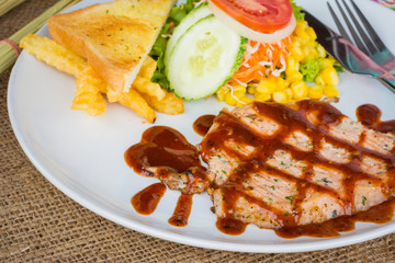 Beef steak with black pepper sauce , salad and French fries on s