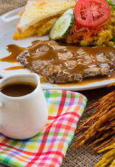 Beef steak with black pepper sauce , salad and French fries on s