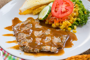 Beef steak with black pepper sauce , salad and French fries on s