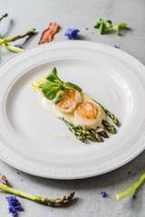 Freshly sauteed scallops with green asparagus