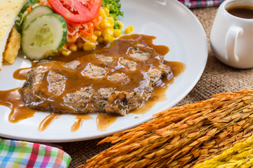 Beef steak with black pepper sauce , salad and French fries on s