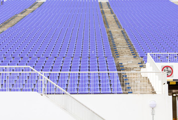 Fototapeta na wymiar Pattern empty purple plastic grandstand seats with number