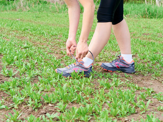  woman athlete tying running shoes.