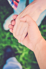 The guy holding the girl's hand. Man and woman. Hand in hand. Top view (vintage)
