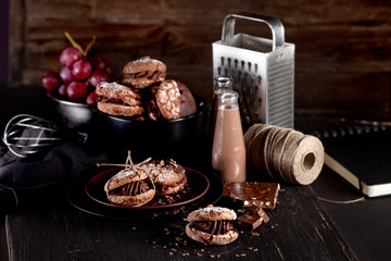 Maroni italian cookies and chocolate milkshakes on dark wooden b