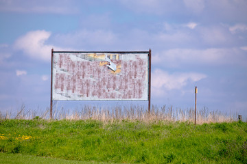 billboard with old torn posters