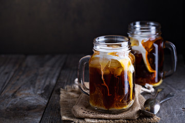 Iced coffee with milk in mason jars