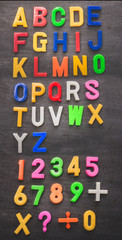 colorful plastic alphabet on black board background
