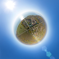 Aerial view of a summer house village at ocean coast. Blue sea. Little planet mode.