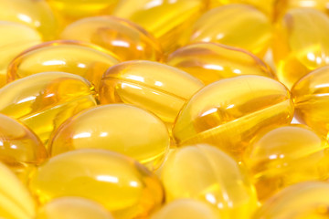 Omega 3 soft gel capsules closeup background