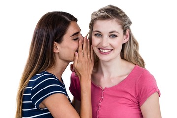 Woman telling secret to friend 