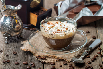 Glass cup of coffee with cream