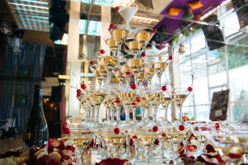 Close-up of the champagne pyramid with a red cherry at the top of each glass