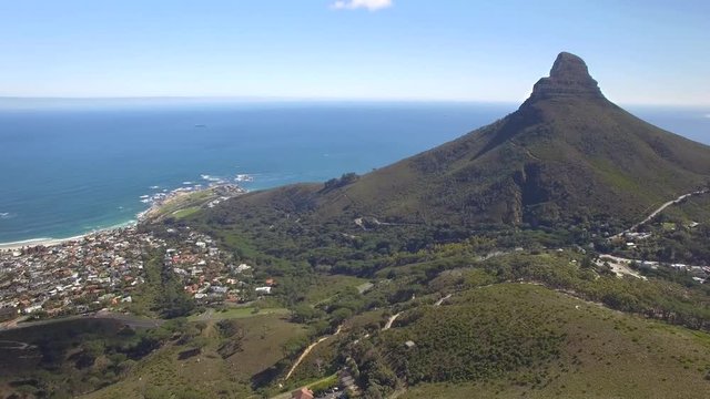 Cape Town city 4K UHD aerial footage pan of Lions Head mountain peak and Camps Bay Beach. Part 2 of 2
