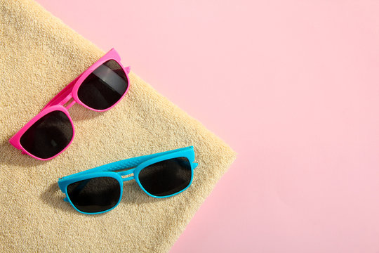 a towel with sunglasses on pink background