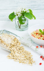 Healty breakfast with porridge, yoghurt and pomergranate