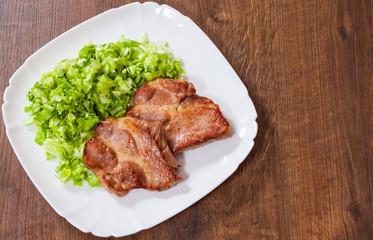 meat fillet steak with vegetables salad in a plate on wooden table