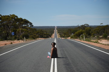 long way! woman sitting on the street