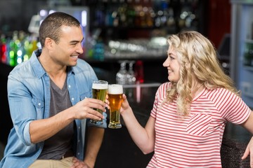 Cute couple toasting with beers