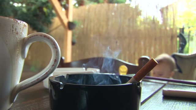 Smoke from a cigarette to the baby
