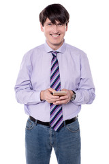Male executive sending  sms with his phone