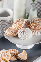Biscuits on gray plate with cups of coffee