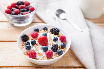 Healthy and nutritious yogurt with cereal and fresh raw berries