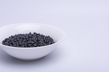 Fototapeta na wymiar Black Soybeans in a white bowl isolated on white background.