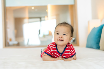 Fototapeta premium Portrait of a newborn Asian baby on the bed